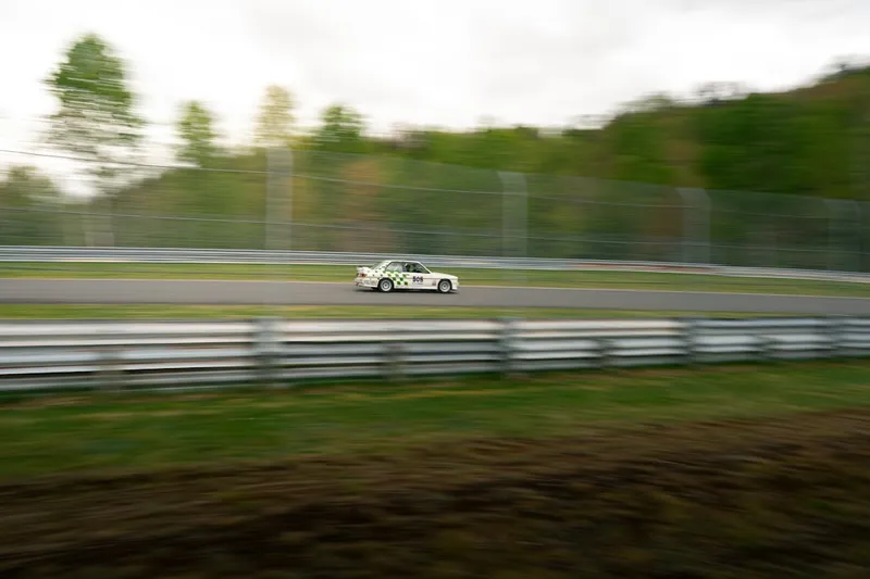 White race car speeding on a track